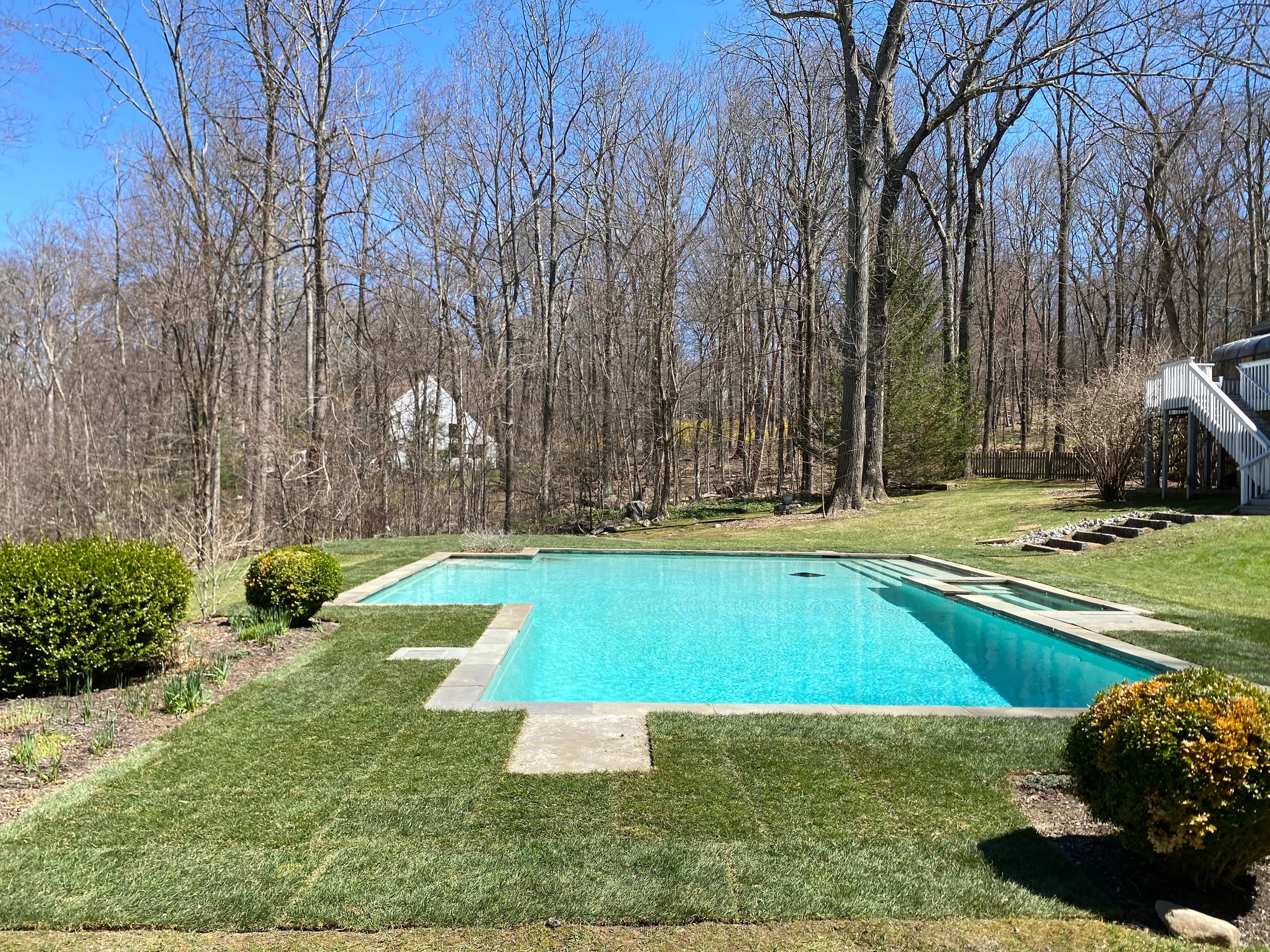 Completed sod installation surrounding an in-ground pool at a home in Redding, CT