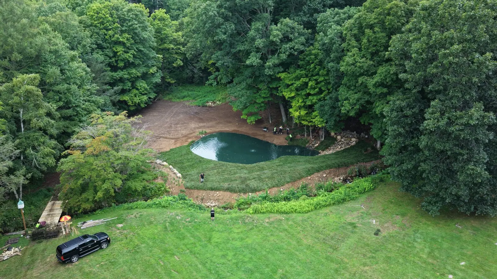 Aerial view of the completed tall fescue lawn surrounding a new pond on a Bridgewater, Connecticut estate