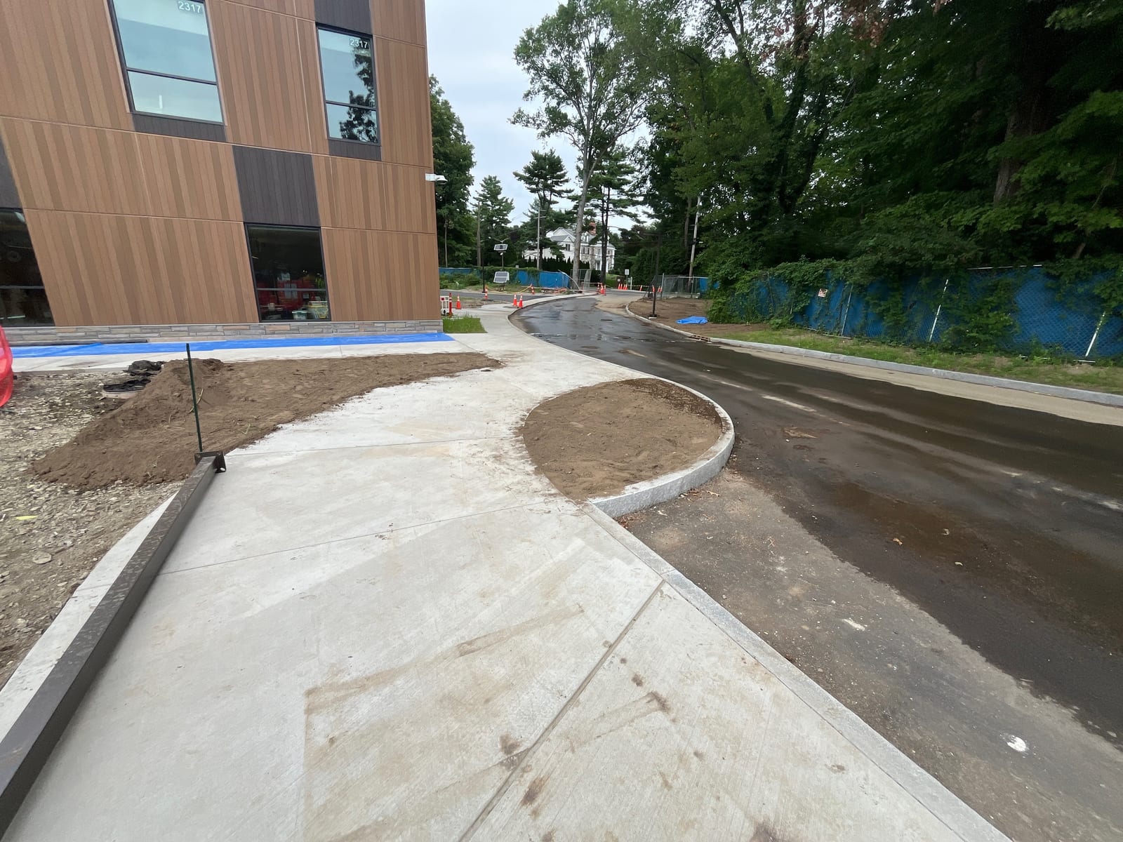 Open soil and new sidewalks defining the future school lawn before sod installation