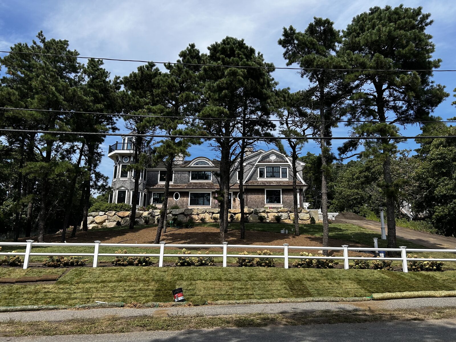 Finished sod lawn at a Chatham, MA estate, running from the road frontage back to mature pines, in a town that regulates lawn fertilizer