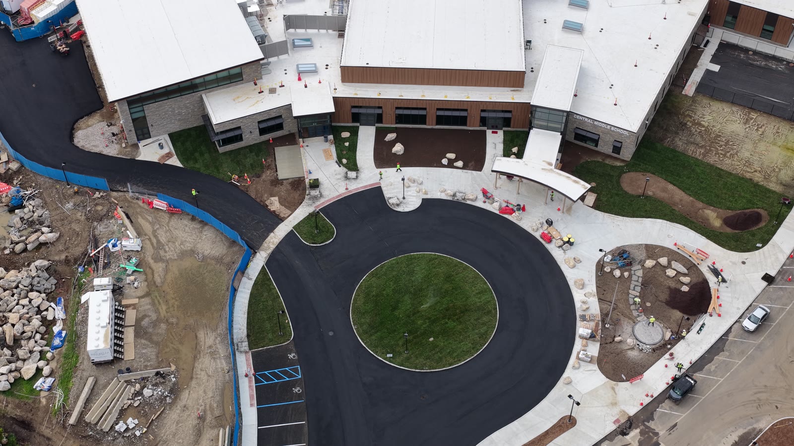 Friday afternoon flyover showing new sod around the entrance circle and along the building while installation remained in progress