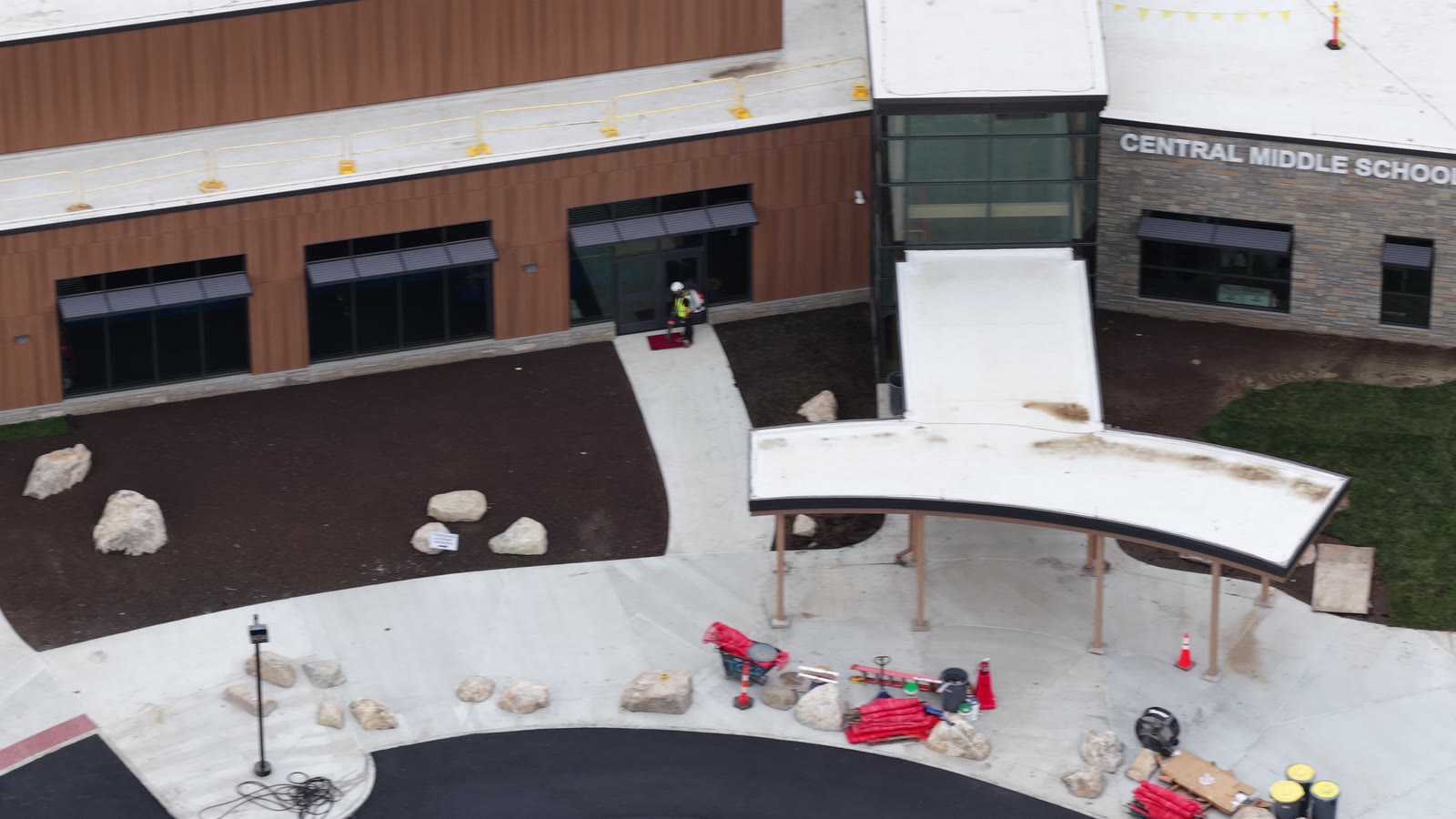 Extended completion flyover over the new building-side lawn, entry walks, and landscaped beds at Central Middle School