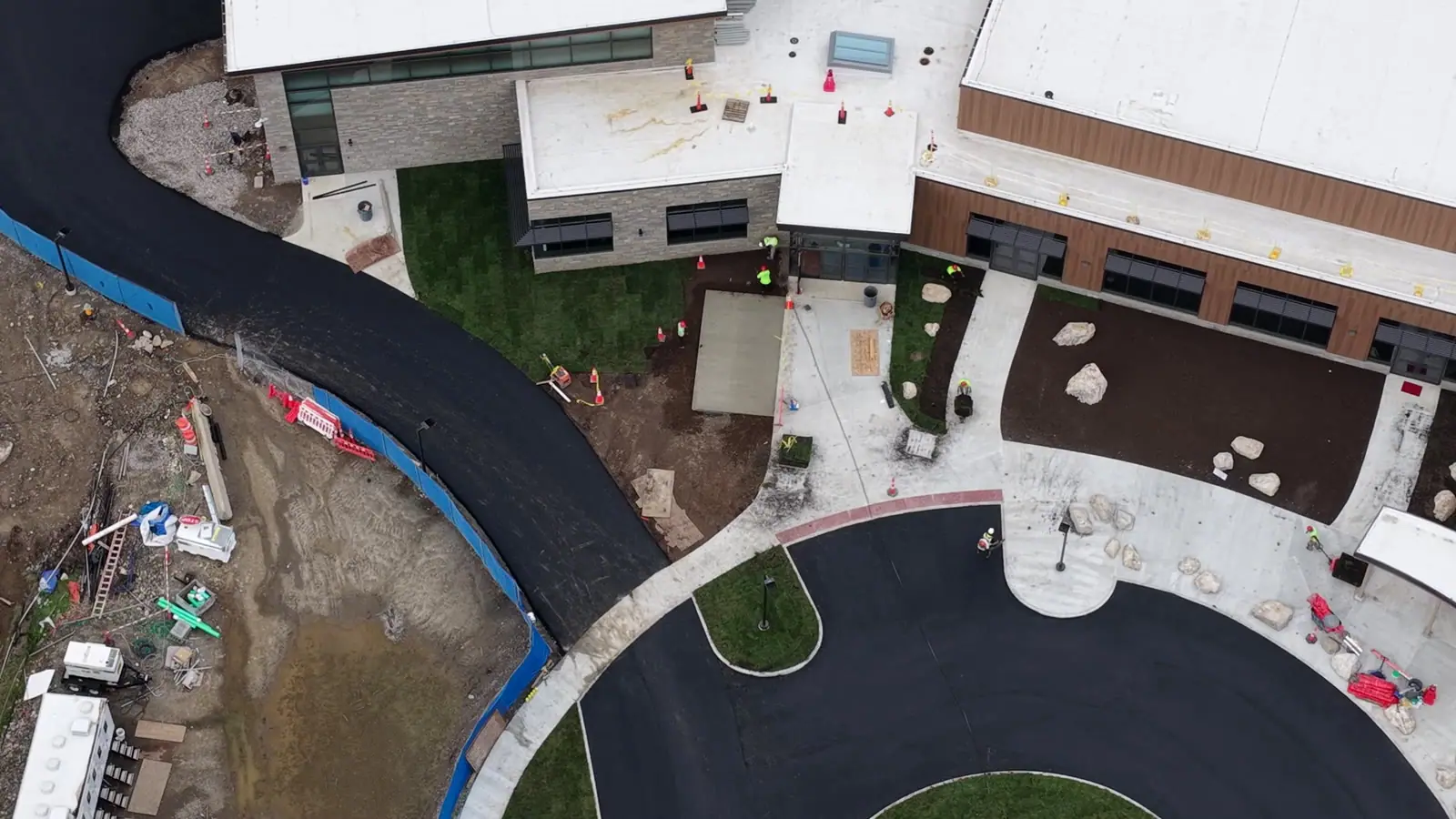 Completion-day flyover showing finished sod along the Central Middle School entrance building, circular drive, and curved walkways