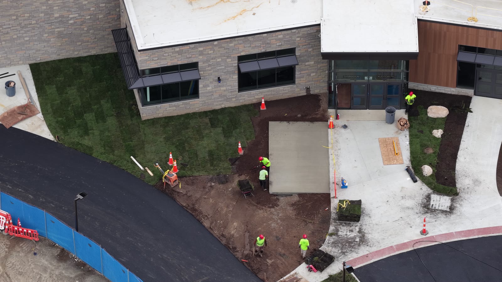 Close aerial detail of finished sod fitted around the main school entrance, walks, and planting beds at Central Middle School