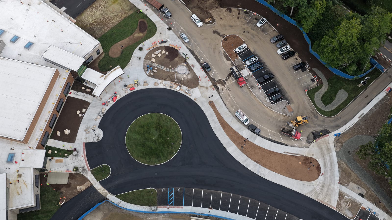 Completed school sod in the foreground with other open-soil construction areas outside CT Sod's scope