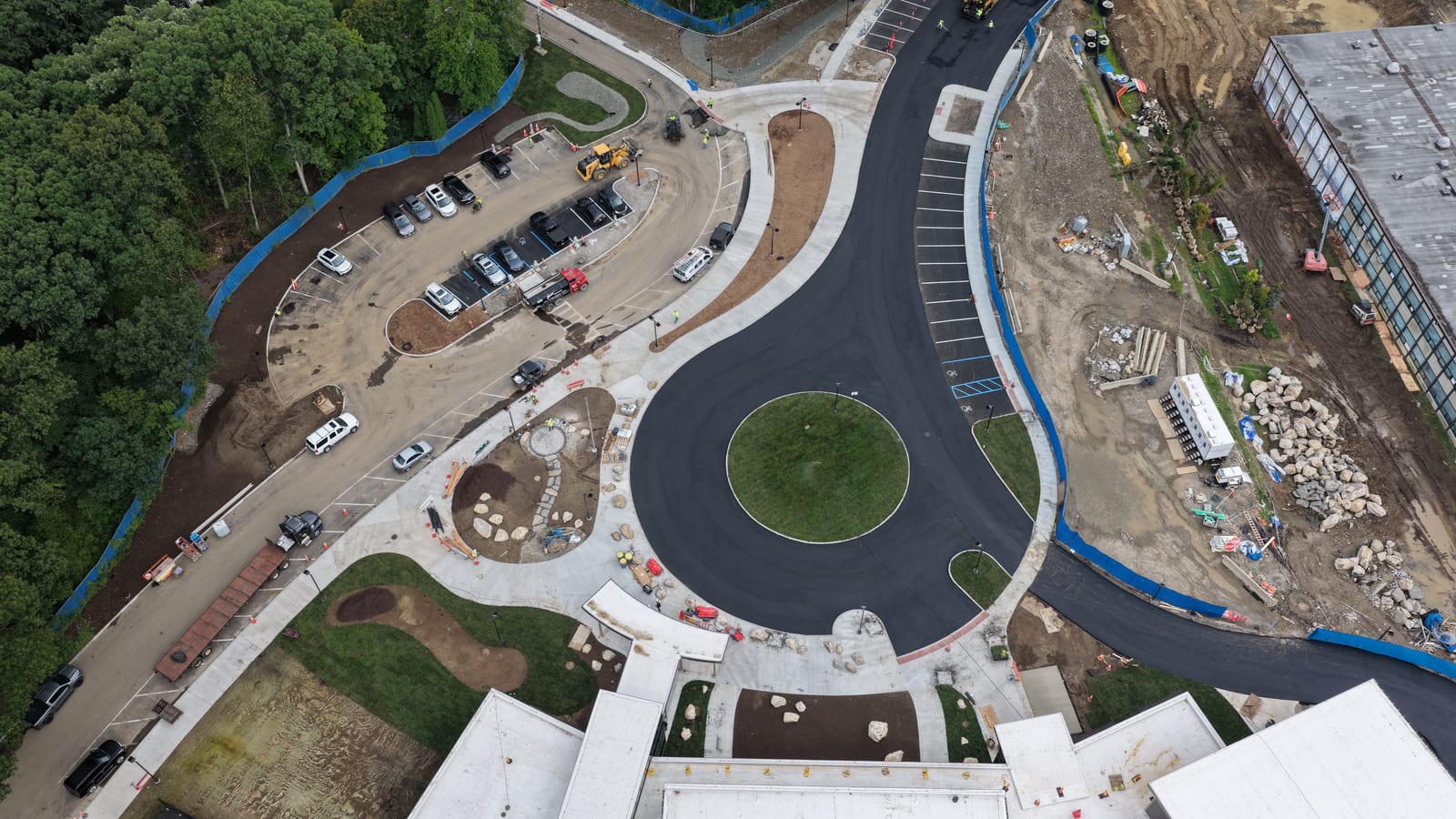 Final aerial descent over the completed Central Middle School entrance sod in Greenwich. CT Sod's approximately 11,000-square-foot sod scope is complete; nearby unsodded areas are part of the project landscaper's separate hydroseed plan