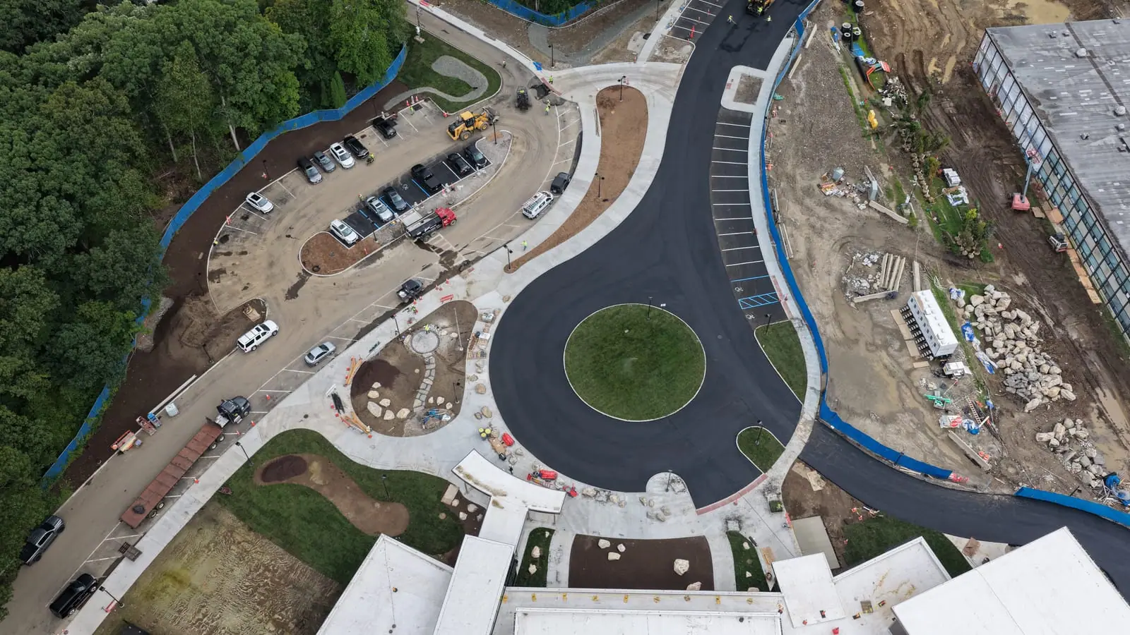 Drone flight opening centered over the finished sod circle at the Central Middle School entrance, then pulling back across the Greenwich campus