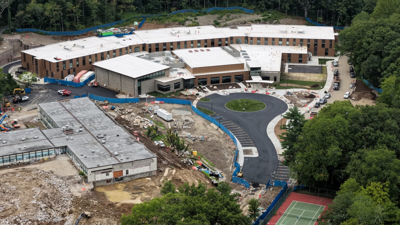 Campus-wide completion flyover showing CT Sod's finished turf zones and the neighboring construction areas the project landscaper will hydroseed. Hydroseeding was not part of CT Sod's work on this project