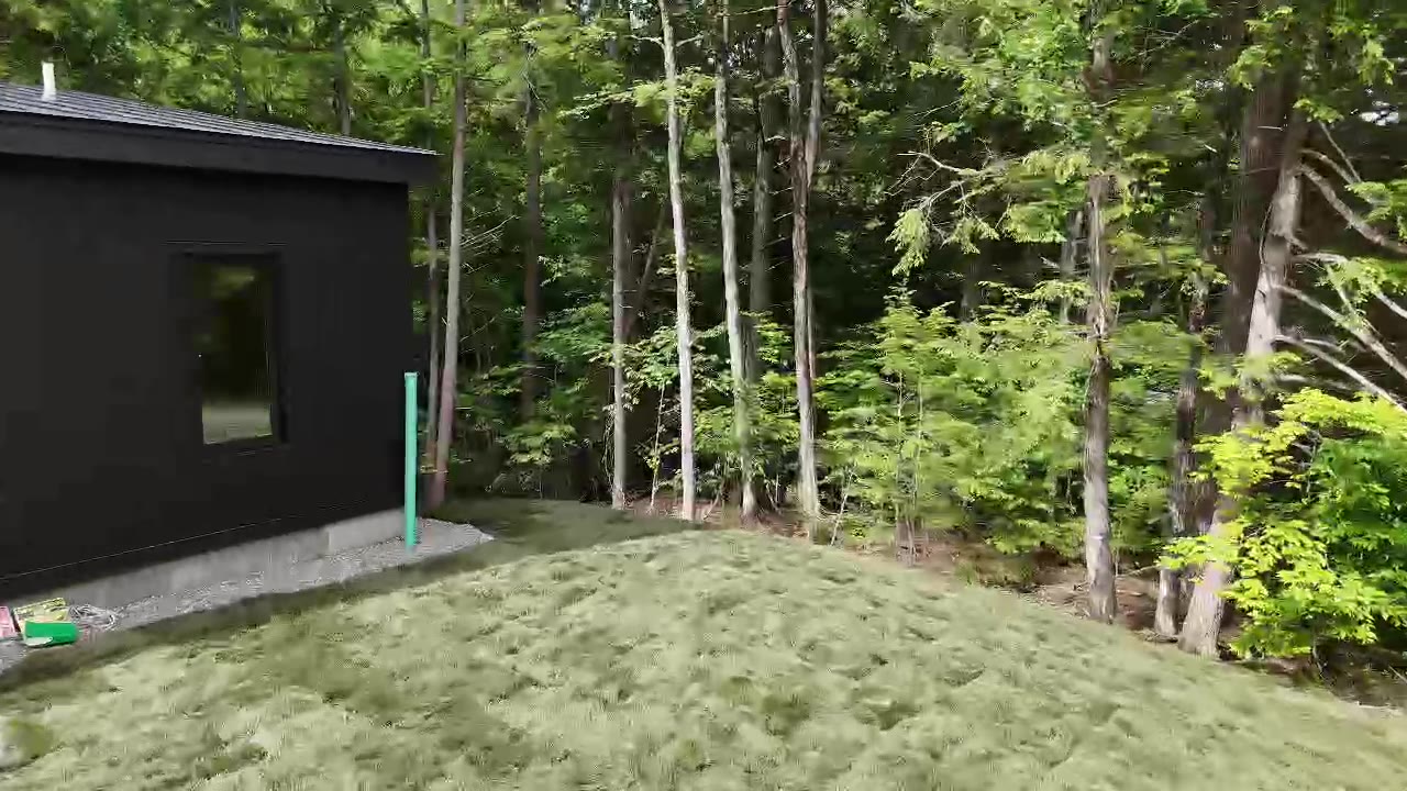 A walkthrough of the finished tall fescue lawn running alongside the modern home and back to the Vermont tree line in Quechee