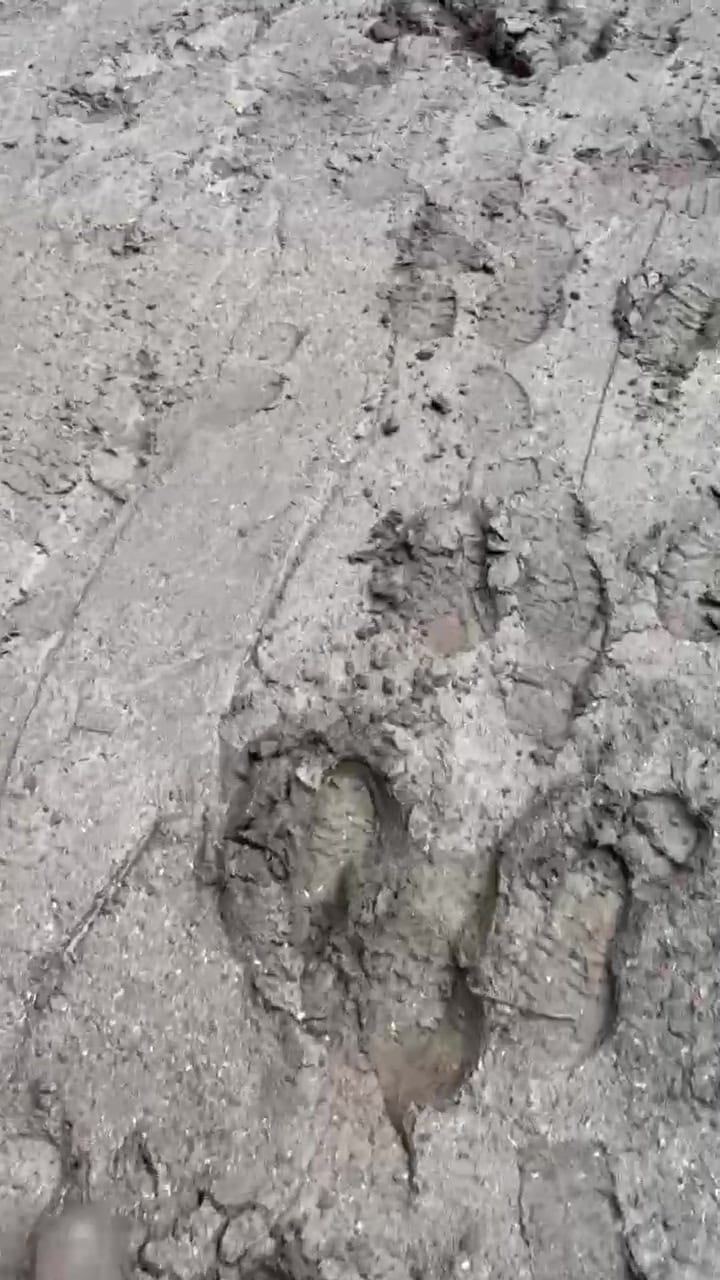 Walking the site at 8:30 a.m. in Quechee — every step sinking into the rain-soaked mud the crew had to work back into shape before a single roll of tall fescue could go down