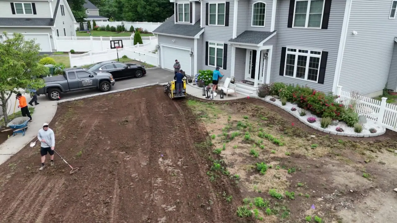 Grading and raking the front yard to a clean, firm bed.
