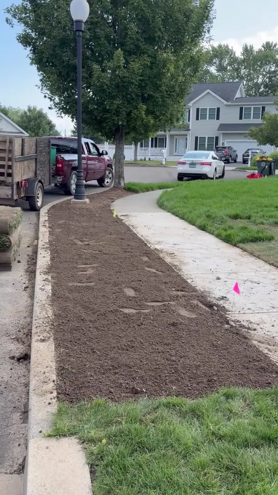 The washed-out strip stripped back to clean soil, fresh rolls staged for round two.