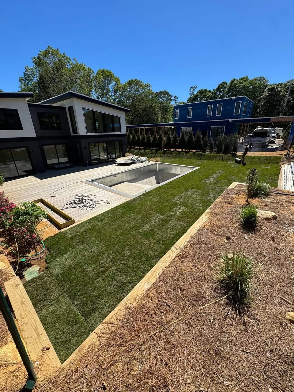 Freshly laid sod lawn beside the pool at a Montauk, NY new build