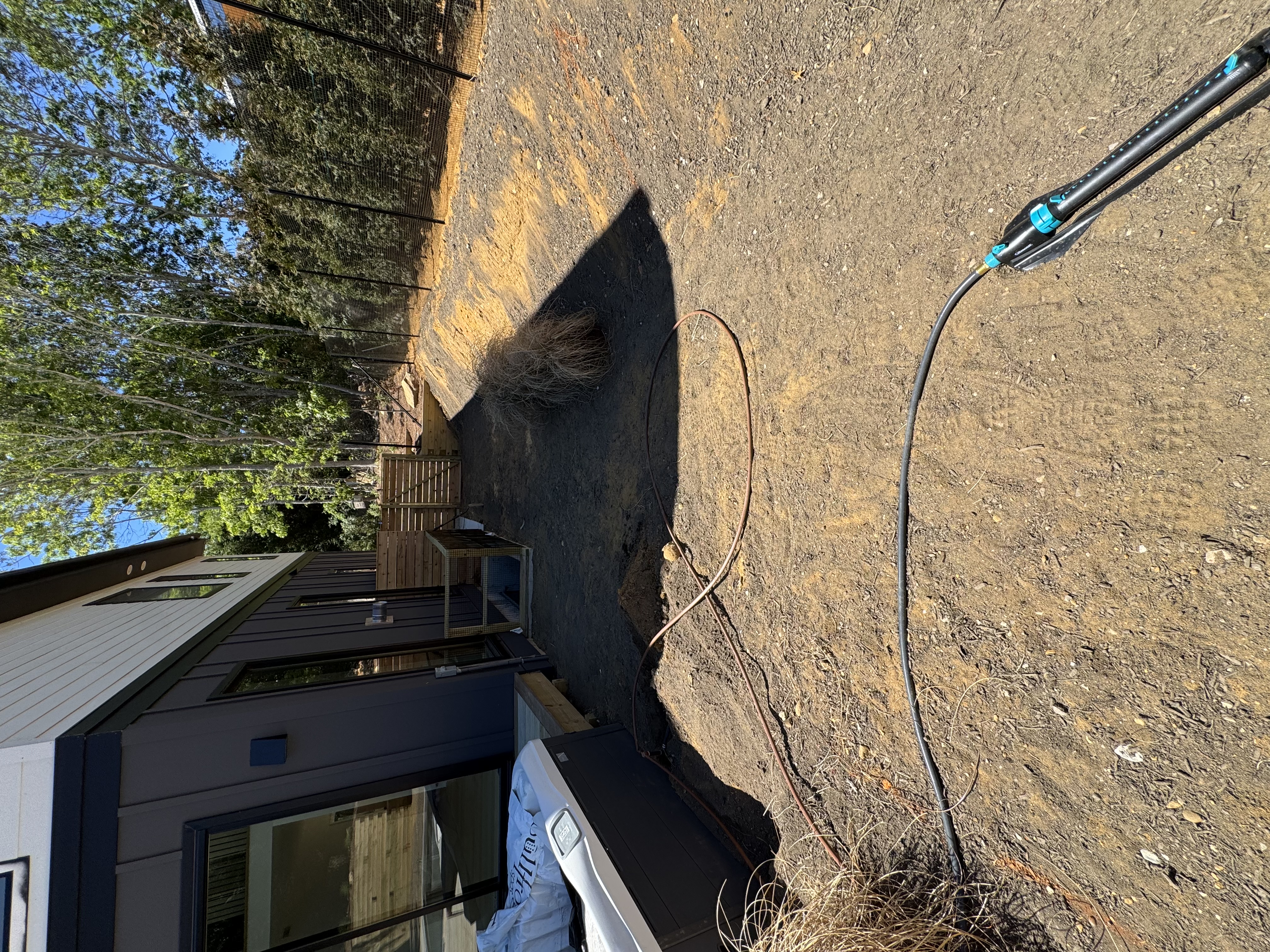Prepped side yard with irrigation lines run and the soil graded, ready for fresh sod