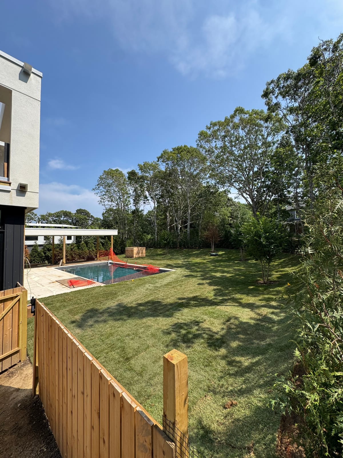Finished sod lawn and pool behind the cedar gate at a CT Sod oceanfront job in Montauk, NY