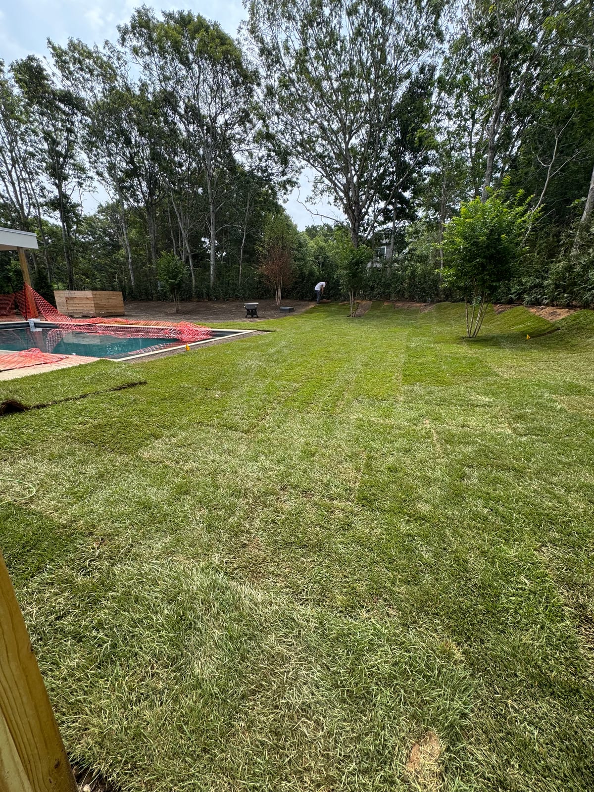 Freshly installed sod lawn surrounding the pool at the 4,500 sq ft Montauk new build
