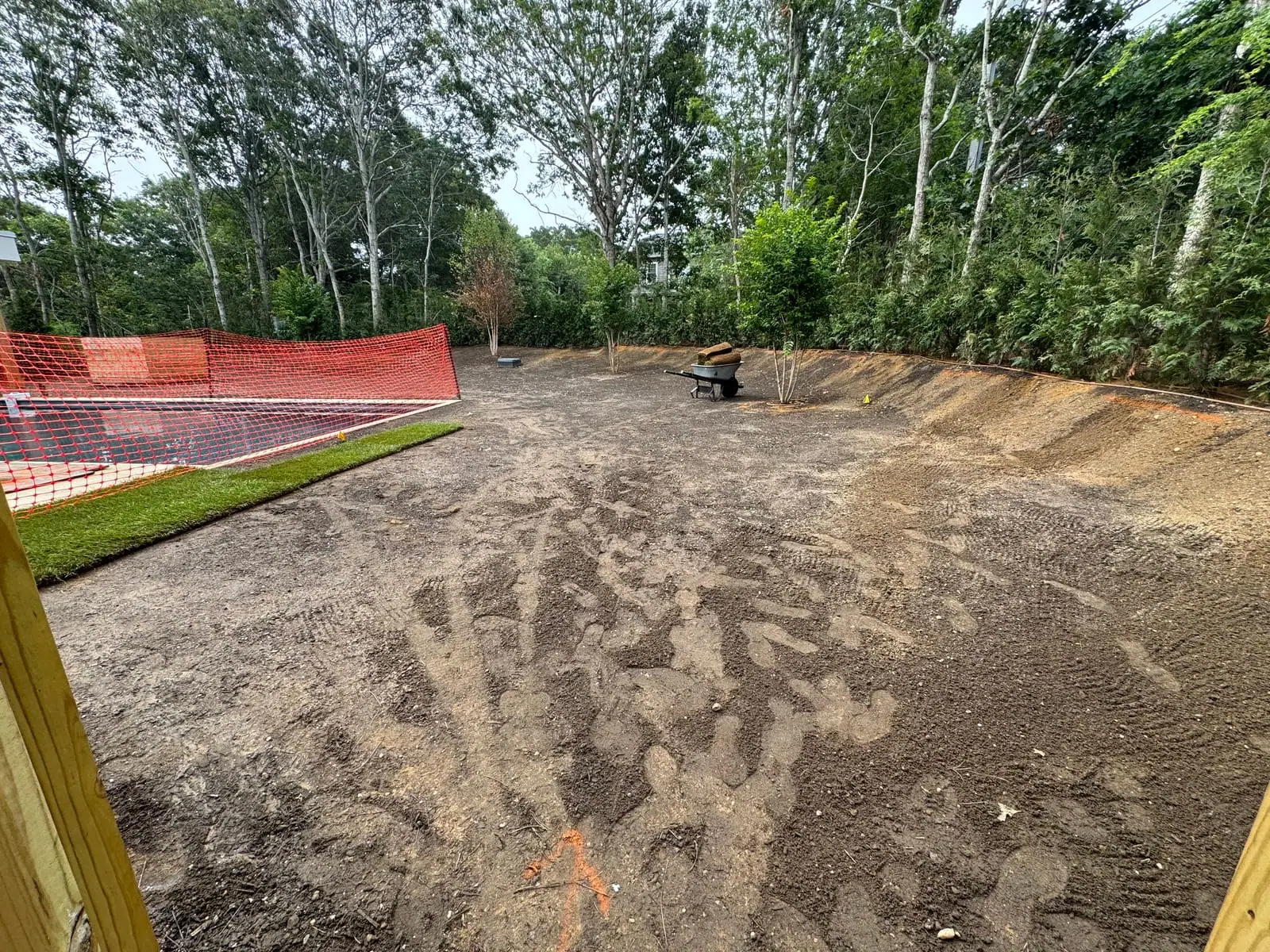 Fresh sod going down beside the pool at a 4,500 sq ft new-build sod installation in Montauk, NY