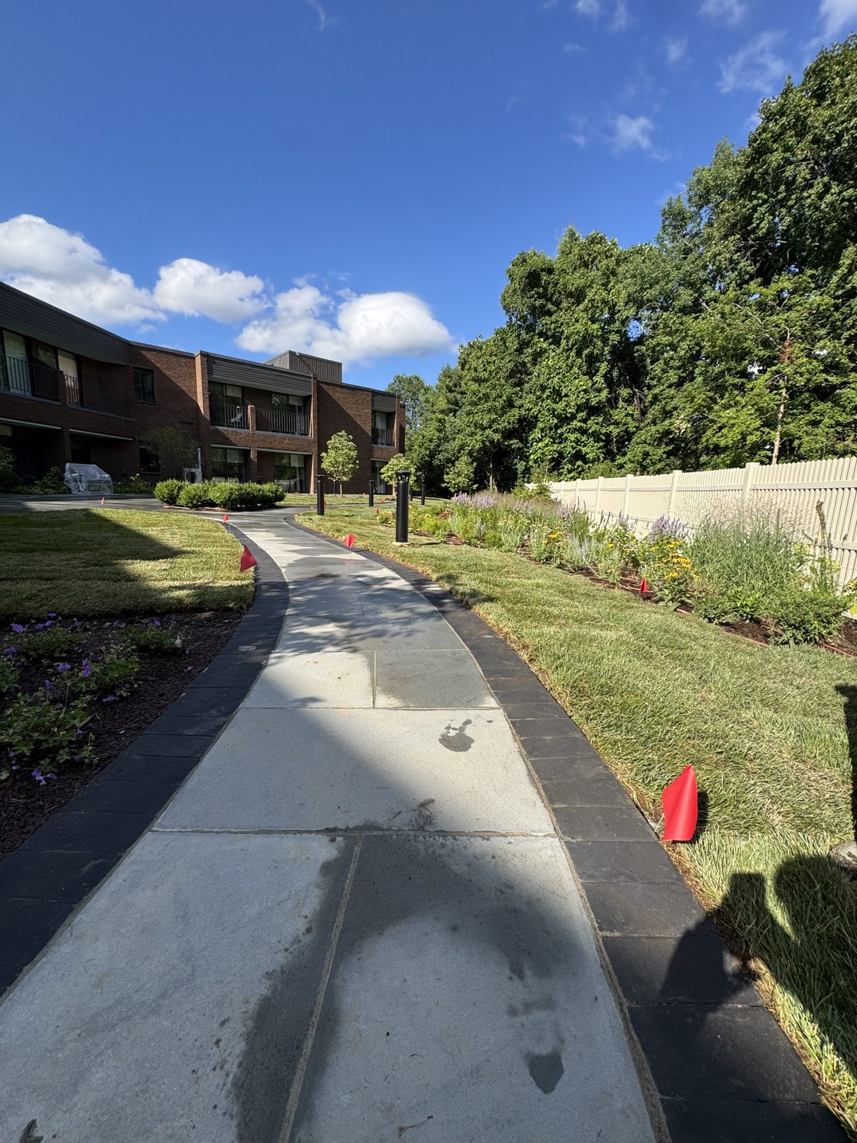 Sunny view of the finished bluestone walkway and new sod at the New Canaan, CT commercial property