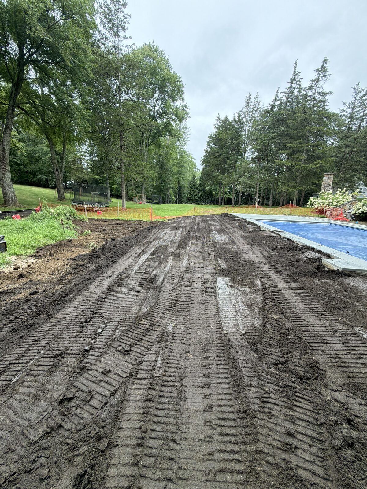 Freshly graded soil beside the covered pool at the New Canaan, CT sod-installation project