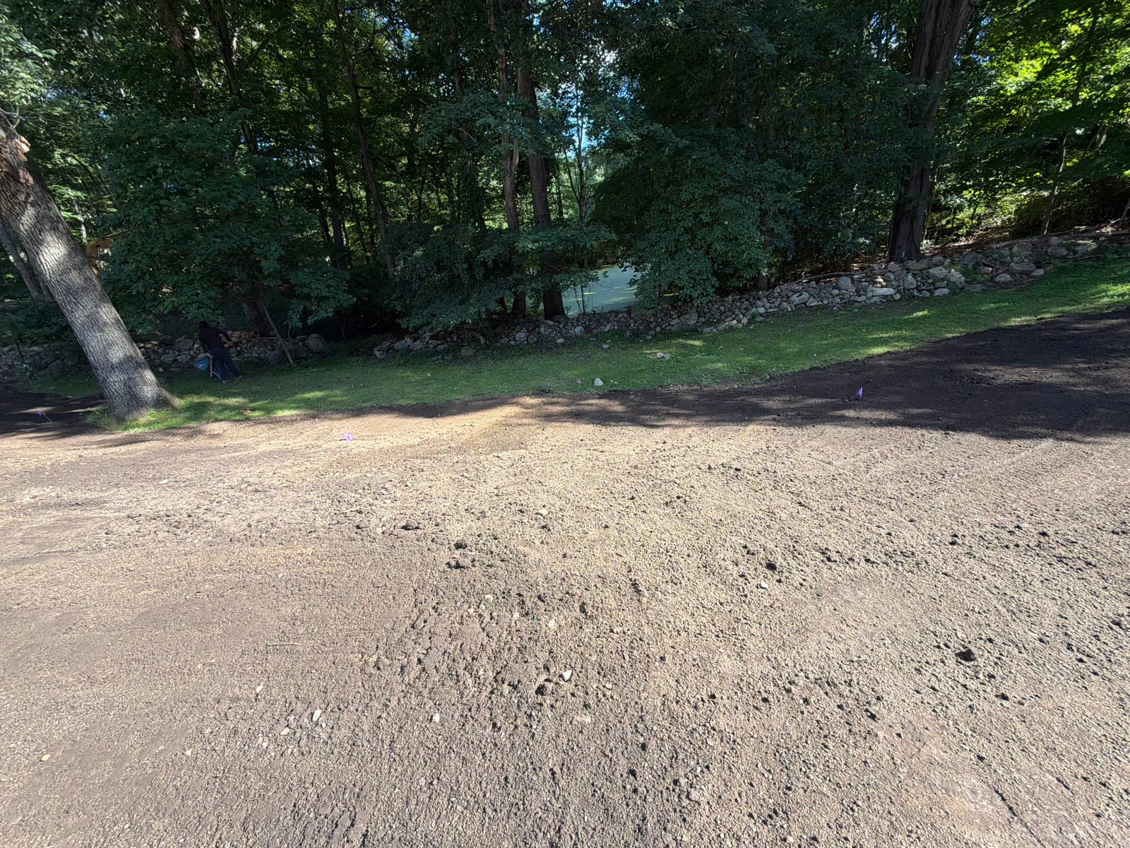 Wide view of the finish-graded lawn areas ready for sod installation at the New Canaan, CT project