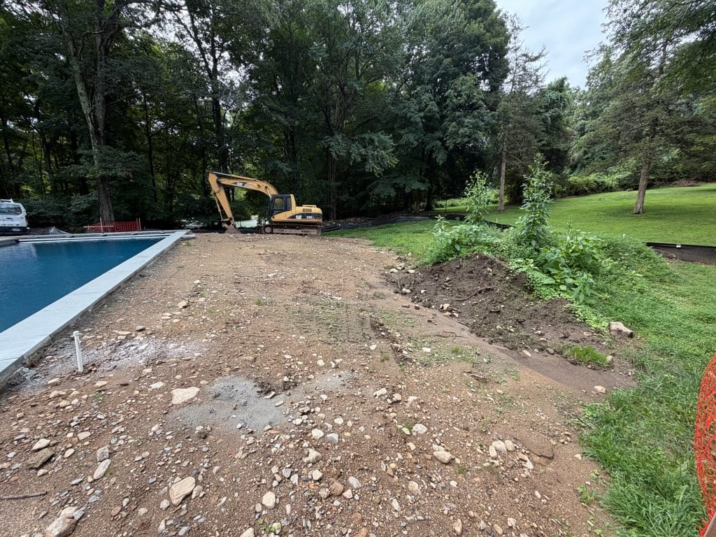 Poolside rough grade at the New Canaan property before the scheduled site work and sod installation