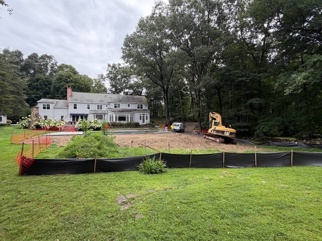 Wide view of a New Canaan, CT residential property before approximately 7,000 square feet of site work, grading, and sod installation
