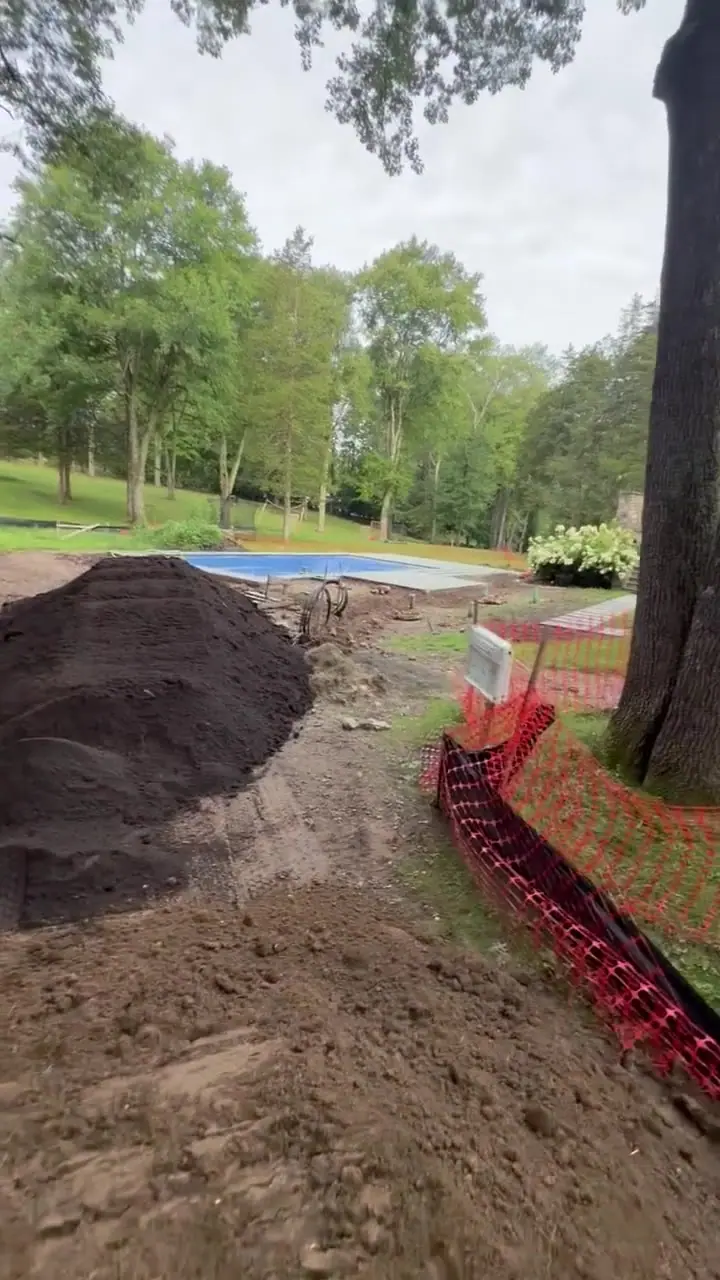 A view from the track loader cab as soil is moved across the New Canaan, CT lawn areas during finish preparation