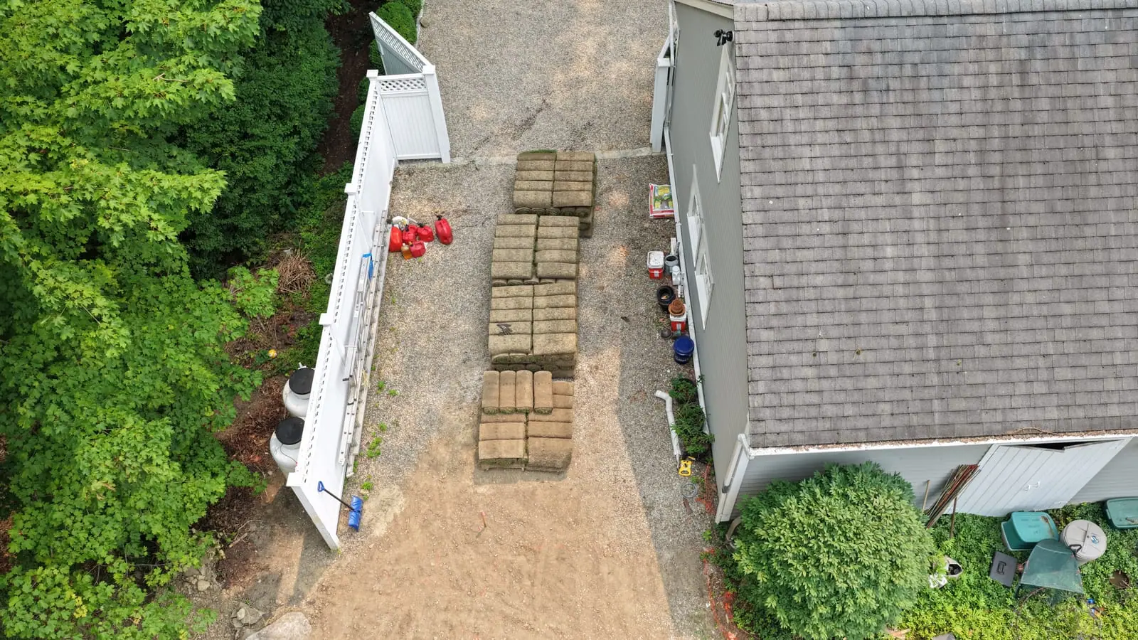 Pallets of fresh farm-cut sod staged in the driveway of a New Canaan, CT home on install day, hours after coming off the farm that morning