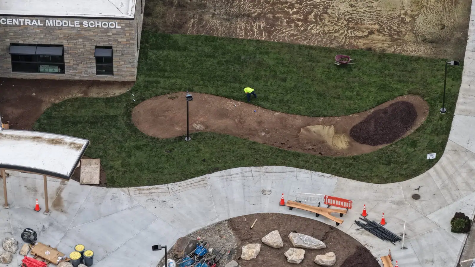 Completed commercial sod installation beside the Central Middle School building and curved walks