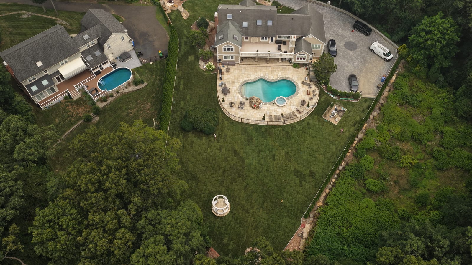 Aerial view of a finished 17,000 square foot CT Sod installation just over the Trumbull line in Shelton, CT — farm-cut sod wall to wall around the new pool and patio