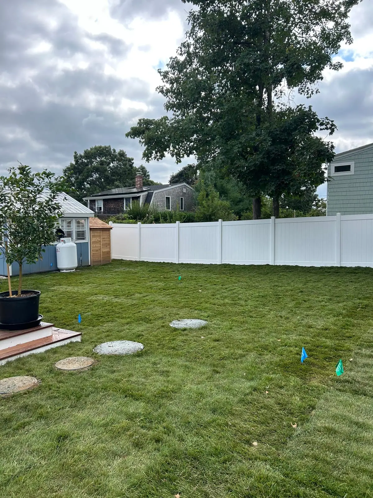 Finished back yard with fresh-cut sod around stepping stones at a Warren, Rhode Island sod installation