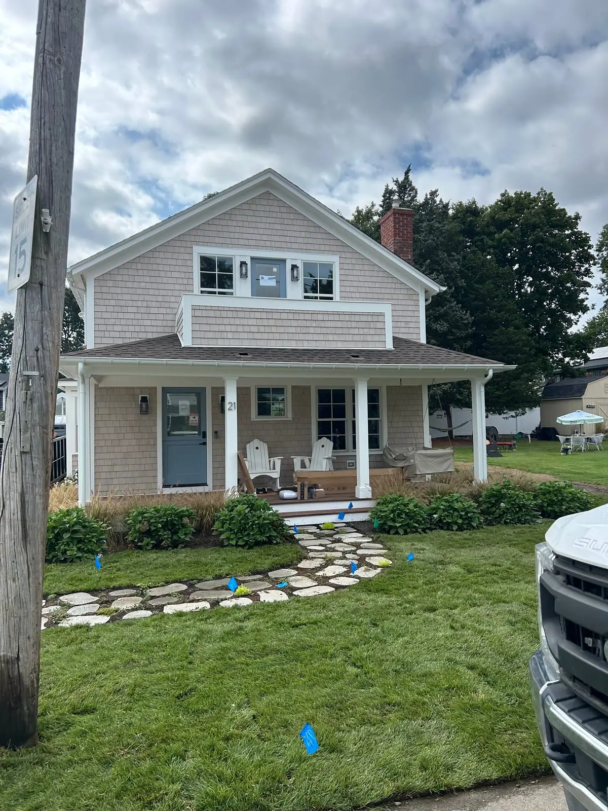 Finished front yard with fresh-cut sod and a stone stepper path at a Warren, Rhode Island sod installation