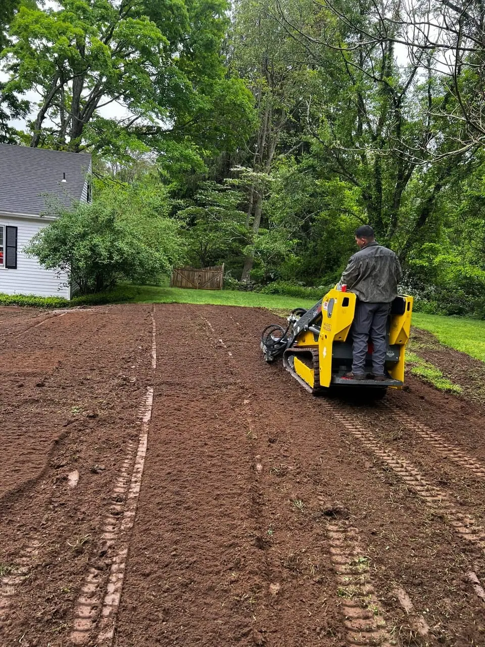 Wacker Neuson mini track loader stripping and tilling the old lawn during a 6,000 sqft sod prep in Westbrook, CT