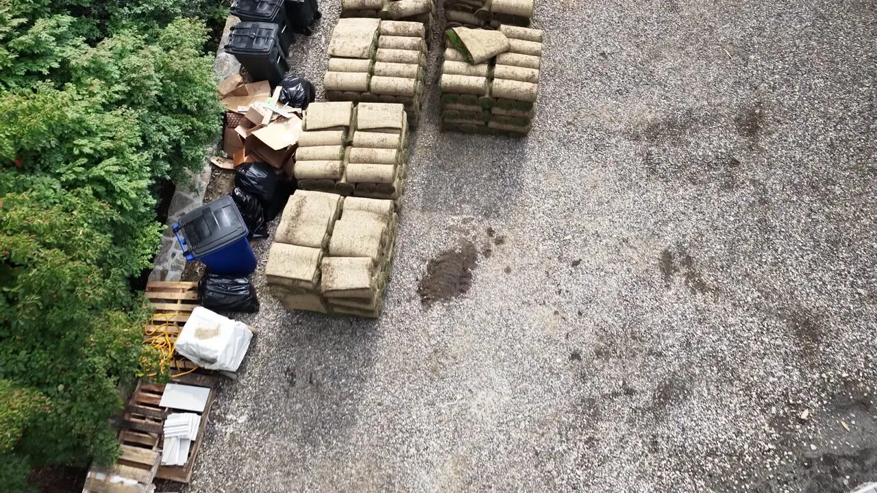 Straight down over the staged pallets and fresh grade, minutes before the first rolls went down