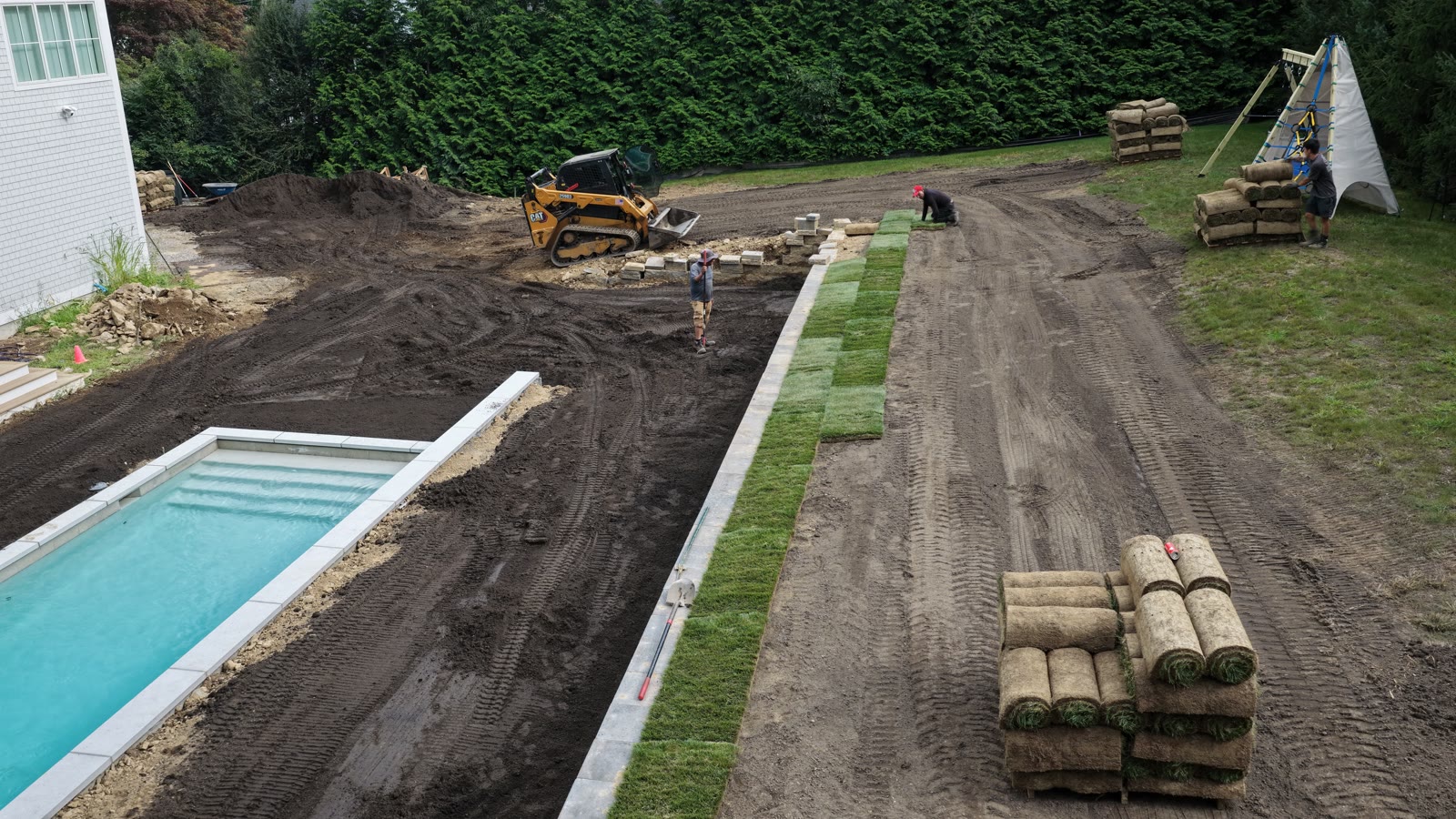 Aerial view of fresh-cut sod pallets staged across the graded Westport property before the 8,000 sq ft one-day installation