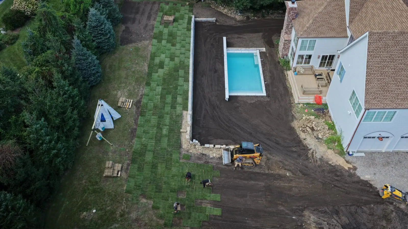 Drone photo of green sod rows going down across a Westport, Connecticut yard in the late afternoon