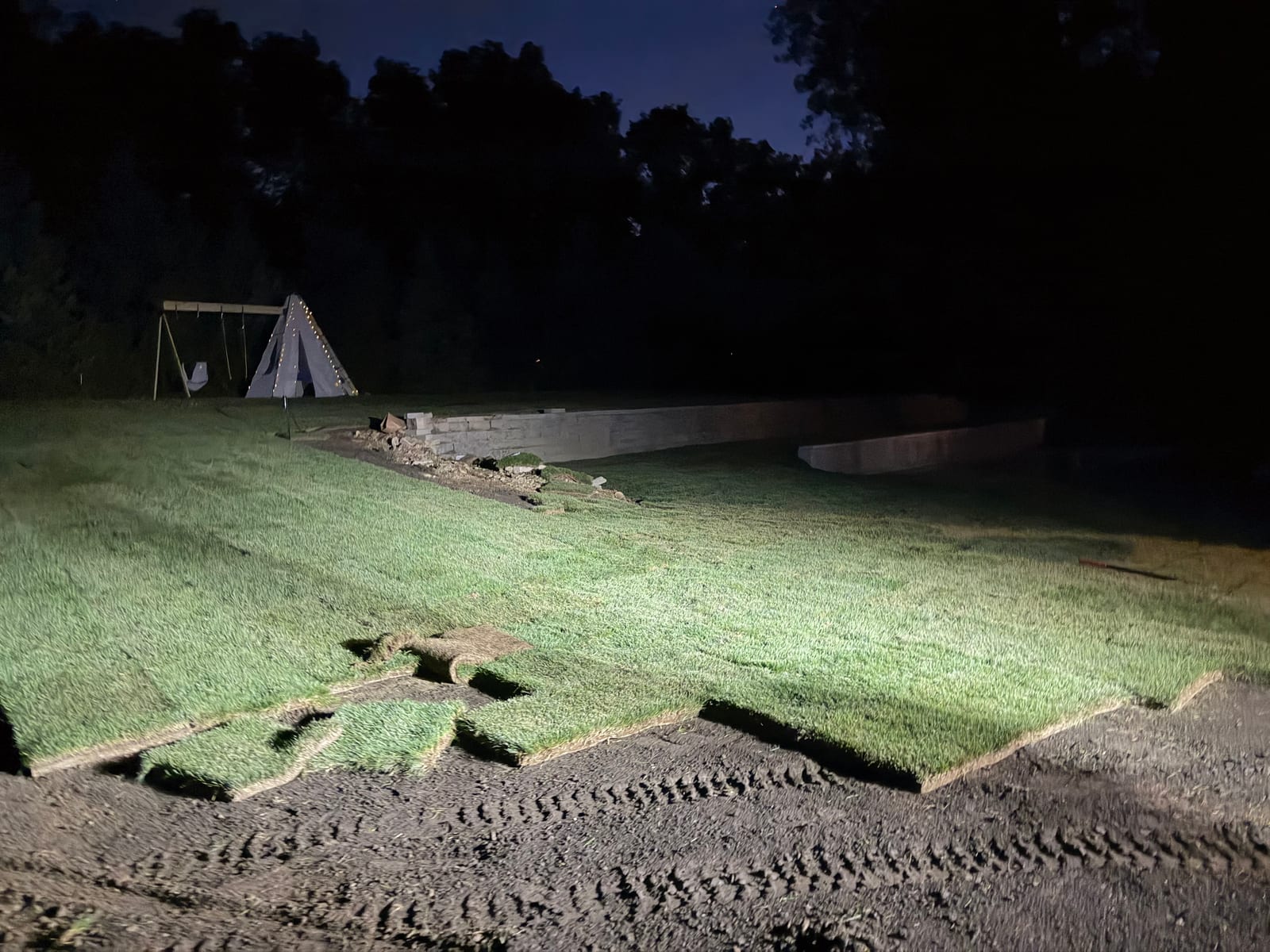 Fresh sod down at dark across the Westport lawn at the end of the one-day 8,000 sq ft installation