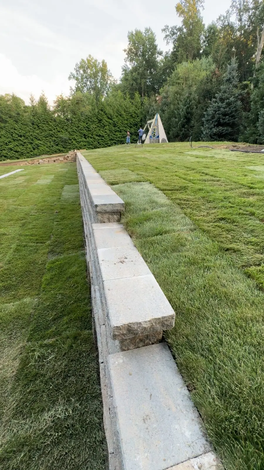 New sod on both tiers of a retaining wall at a Westport, Connecticut home