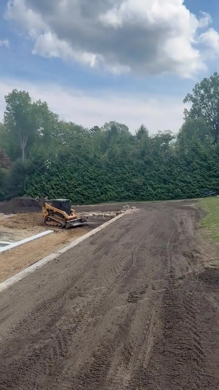 2:12 p.m. Friday in Westport — a short walk down the newly spread topsoil grade while machine and hand-raking work continues beside the separate pool project