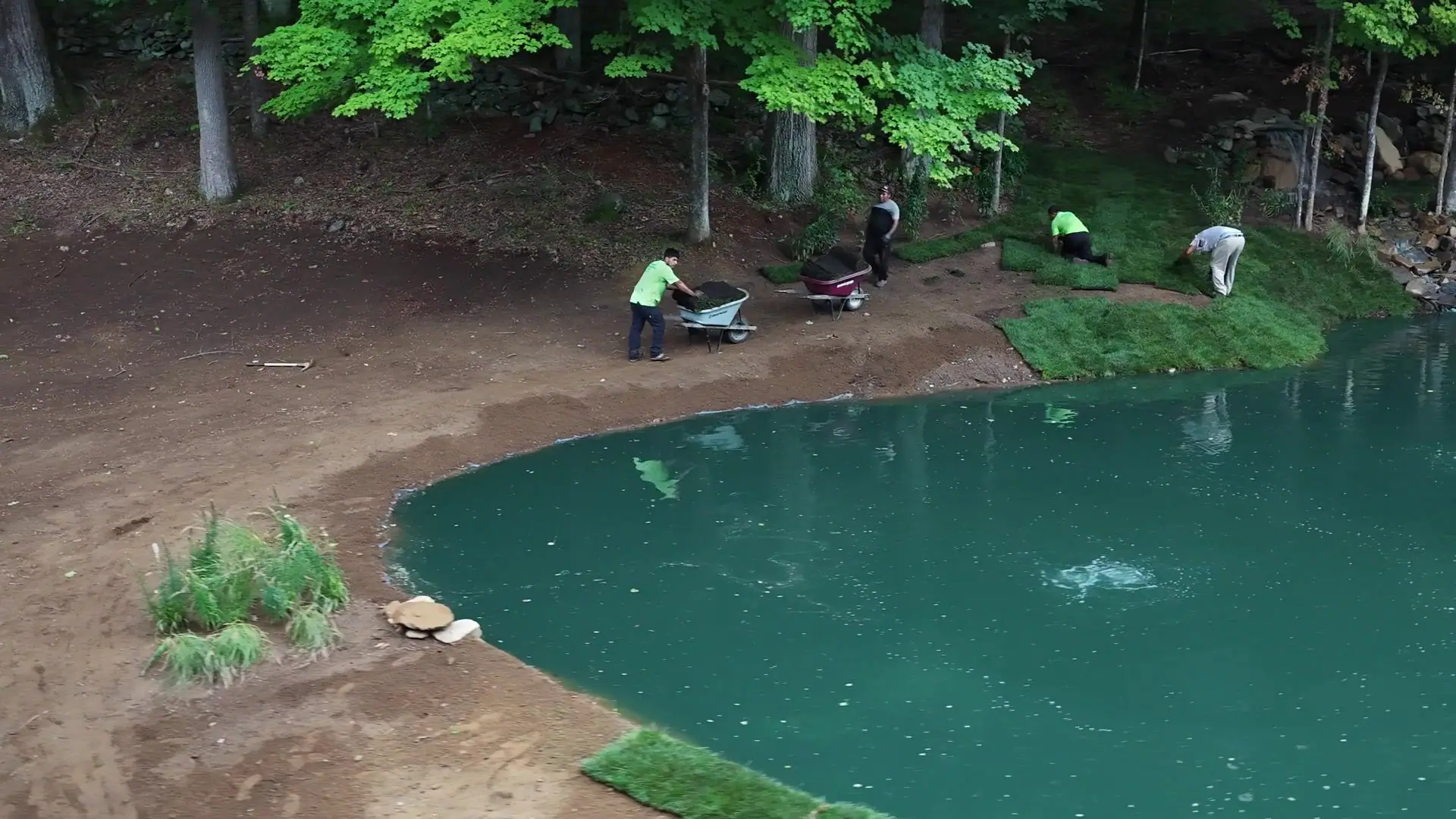 A wider installation-day pass from the pond landscape toward the Lake Lillinonah area, with fresh tall fescue going down below