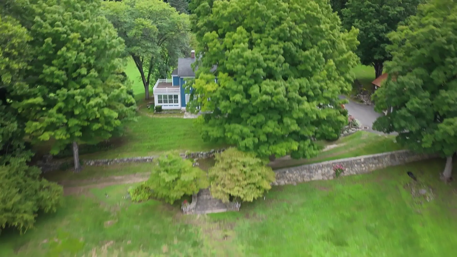 Property-wide installation-day flyover showing the house, estate grounds, and pond-side tall fescue work in Bridgewater, Connecticut