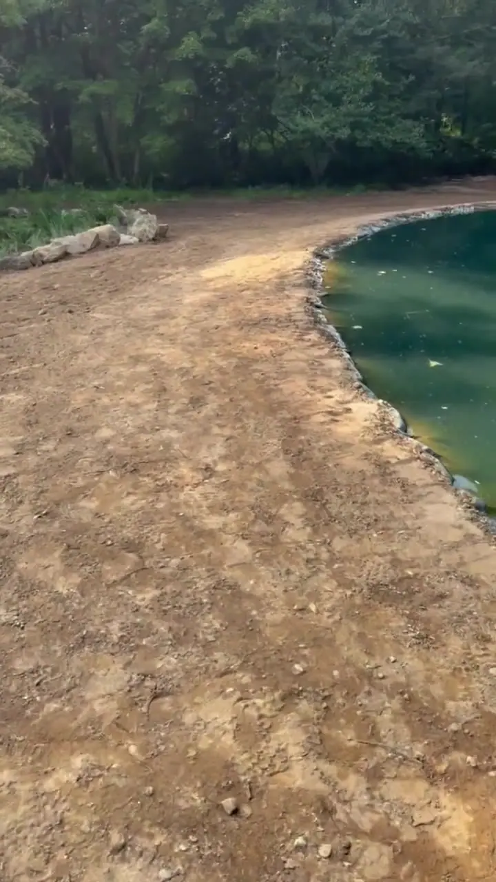 Customer-supplied drone walkthrough of the Lake Lillinonah-area Bridgewater estate, moving from the water to the prepared pond landscape before CT Sod installed the 9,000-square-foot tall fescue lawn
