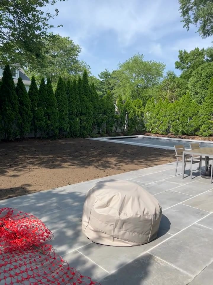 Prep done — clean screened topsoil graded and ready, wrapping the new pool and stone patio