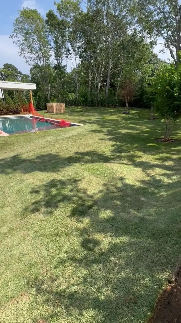 Walkthrough of the finished 4,500 sq ft sod lawn wrapping the pool at the Montauk, NY new build