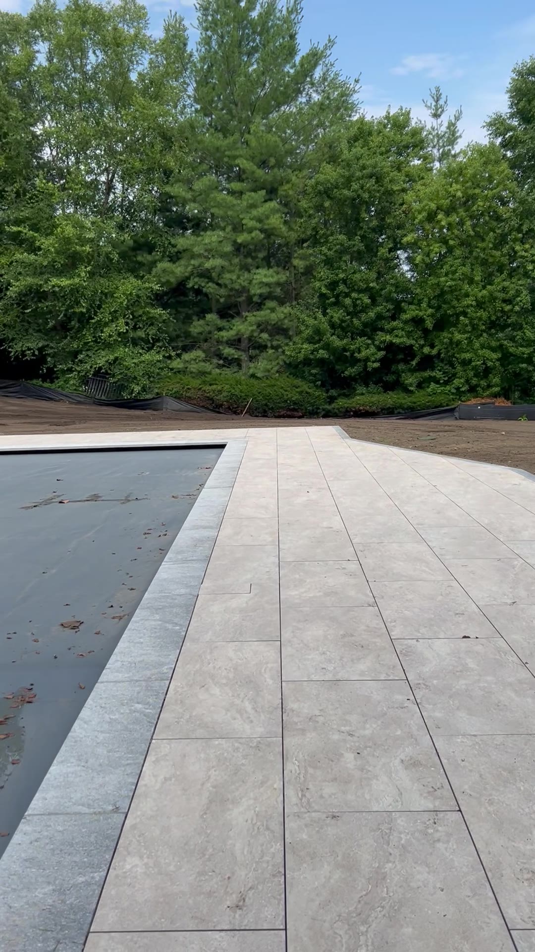 A slow walk across the sod-ready grade — 12,000 square feet worked loose, raked smooth, and pitched to shed water away from the new pool and patio
