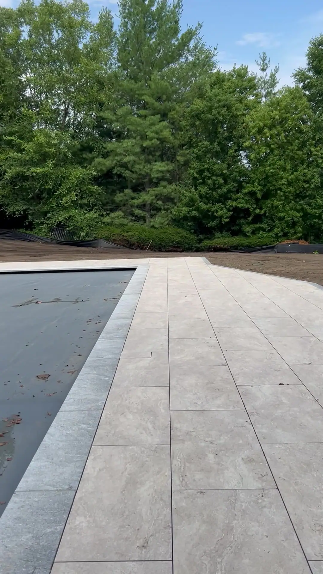 A slow walk across the sod-ready grade — 12,000 square feet worked loose, raked smooth, and pitched to shed water away from the new pool and patio
