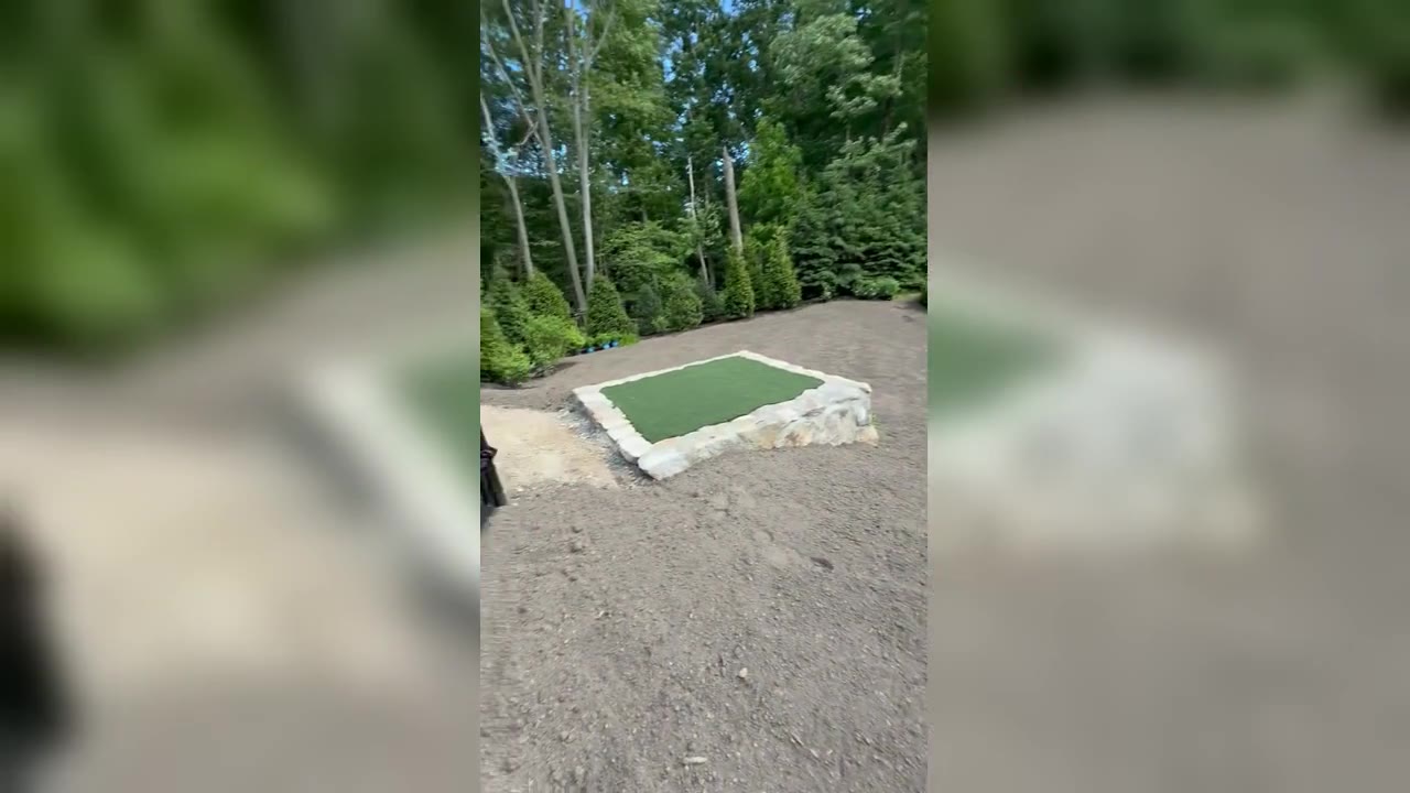 Final sod prep in the backyard of a New Canaan, CT estate — grading around the pool and putting green before fresh-cut sod is laid